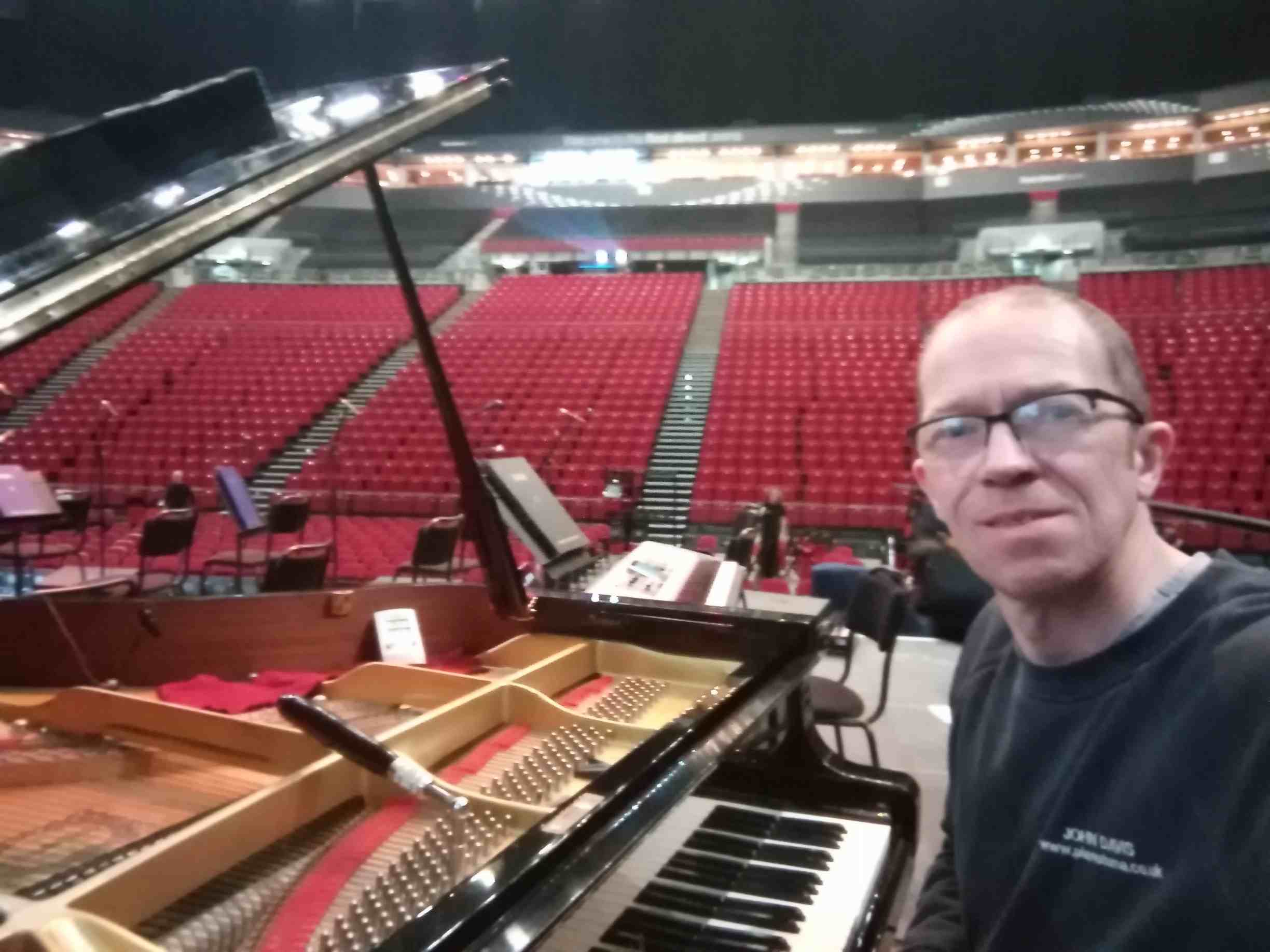 John Davis tuning a piano at the First Direct Arena